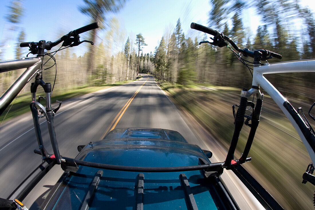 Blurred image of mountain bikes on a roof rack near Lake Tahoe, California Lake Tahoe, California, USA