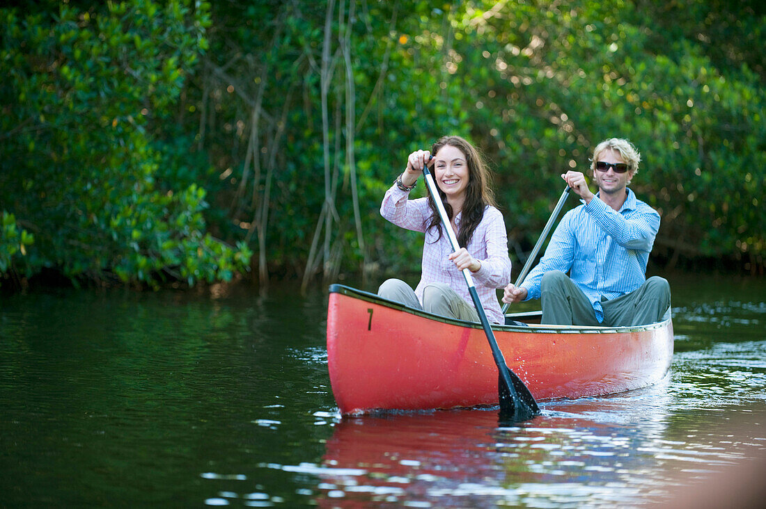 A couple paddles a canoe in Everglades National Park, Florida Florida, USA