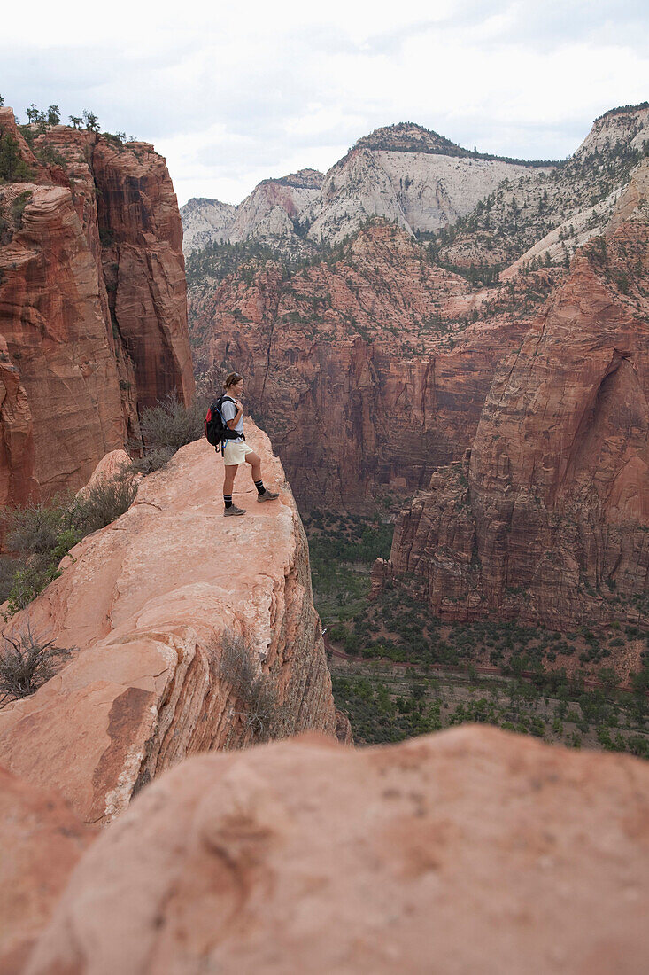 A woman overlooking Zion National Park on the Angel's Landing Trail, Zion National Park, Utah Zion National Park, Utah, USA