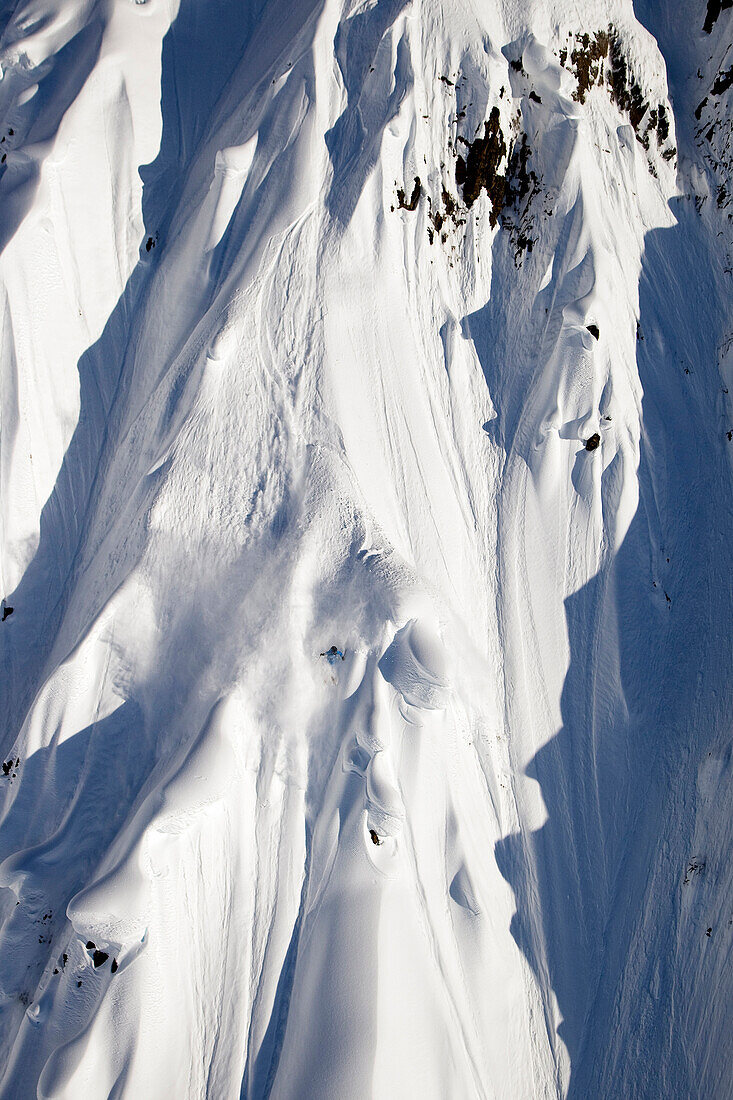 A male extreme skier skis a big mountain first descent in Haines, Alaska Haines, Alaska, USA