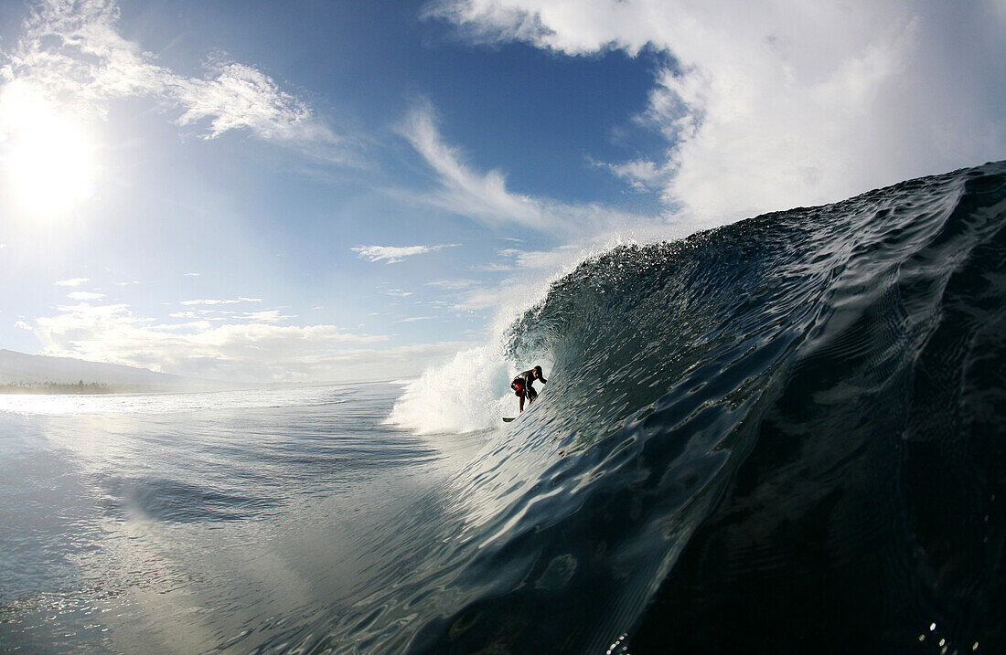 A surfer enters a barrel wave at Maninoa, Upolu, Samoa Maninoa, Upolu, Samoa