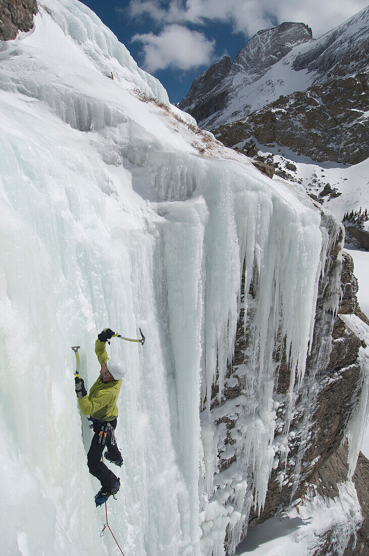 A man ice climbing up frozen waterfall at Willow Lake in the Sangre De Cristo Mountains, Crestone, Colorado Crestone, Colorado, USA