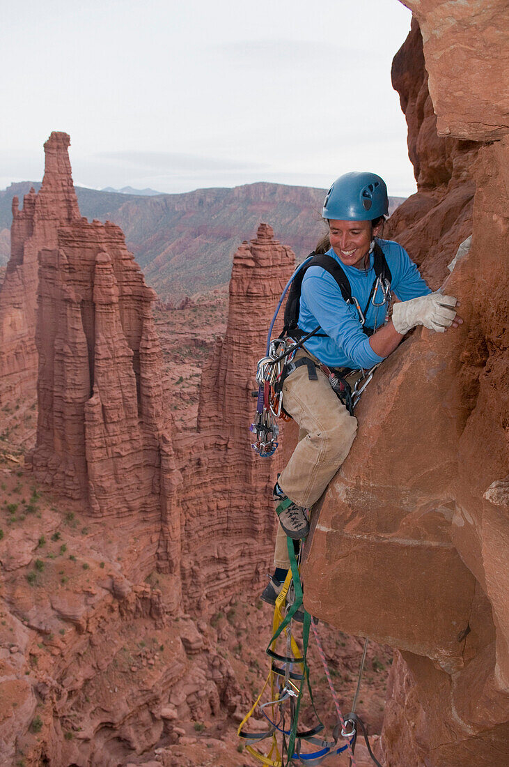 A woman rock climber in the Fisher Towers, Utah Moab, Utah, USA
