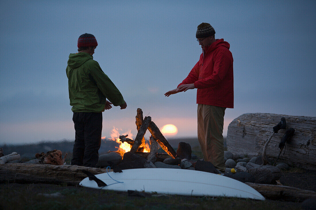 Two men stand around a camp fire on The Lost Coast, California Shelter Cove, California, USA