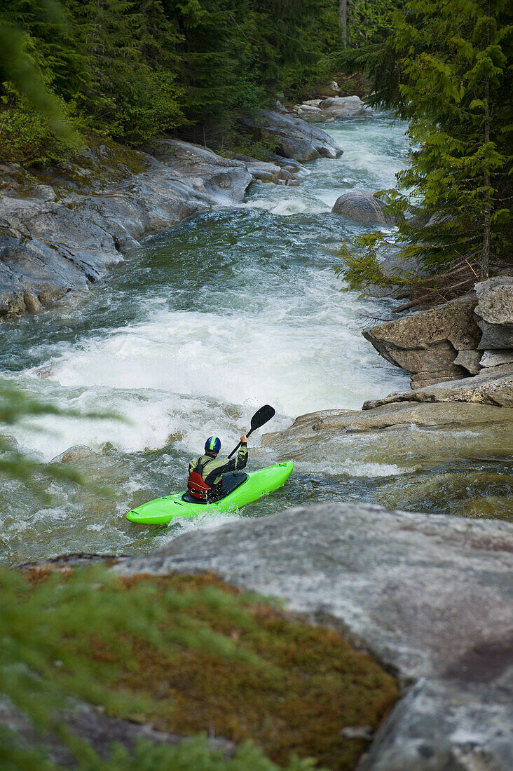 A whitewater kayaker sets up for a drop on a high mountain river Idaho, USA
