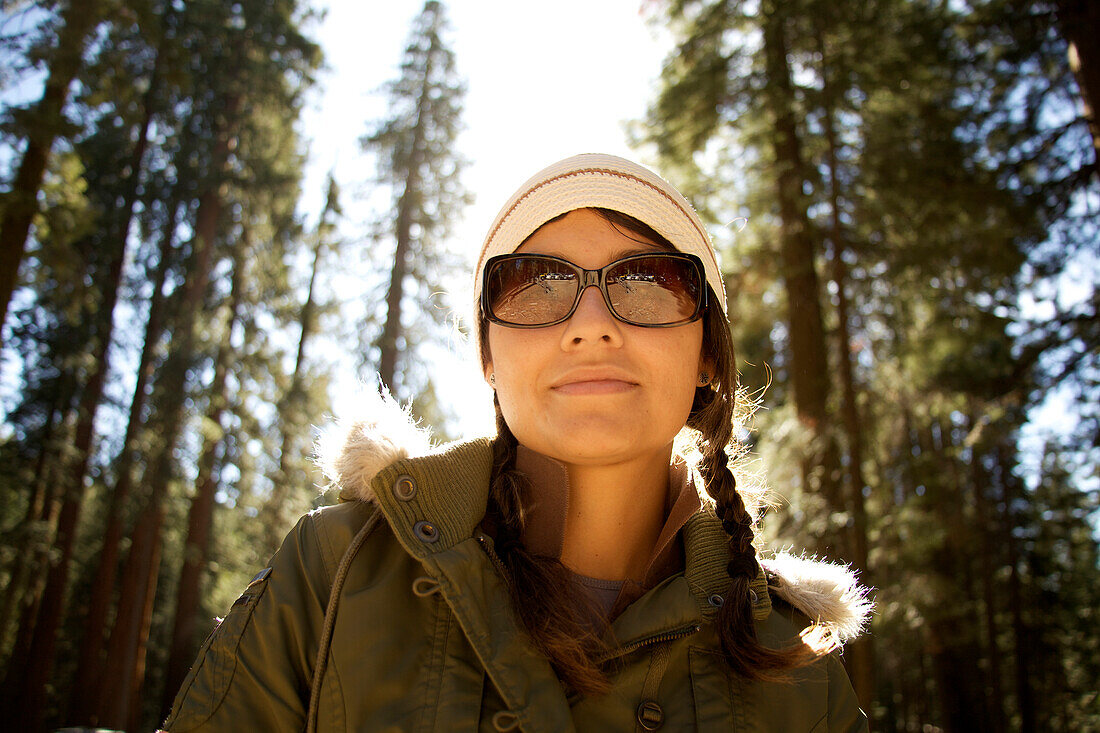Woman in sunglasses looks down at the camera after hiking Yosemite National Park, California Yosemite National Park, California, USA