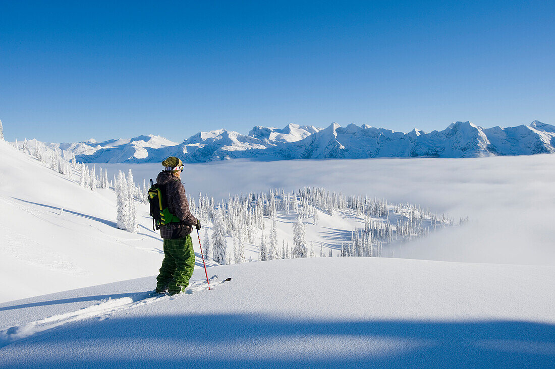 Man traversing on skis, BC, Canada Monashee Mountains, British Columbia, Canada
