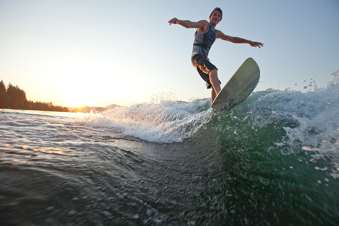 Young man wakesurfing in Idaho Sandpoint, Idaho, USA