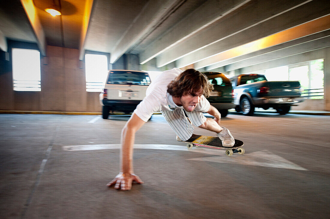 A young man skateboards through a parking garage in Savannah, GA Savannah, Georgia, USA