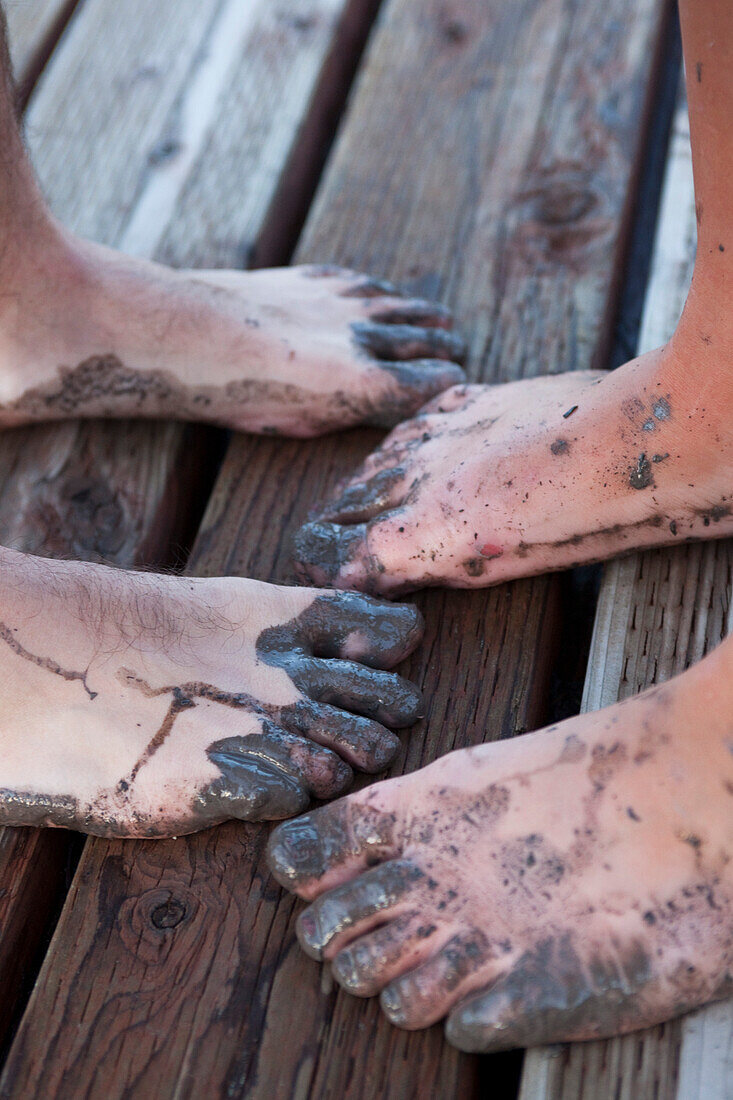 A young man and woman's dirty feet after playing in the mud Sandpoint, Idaho, USA