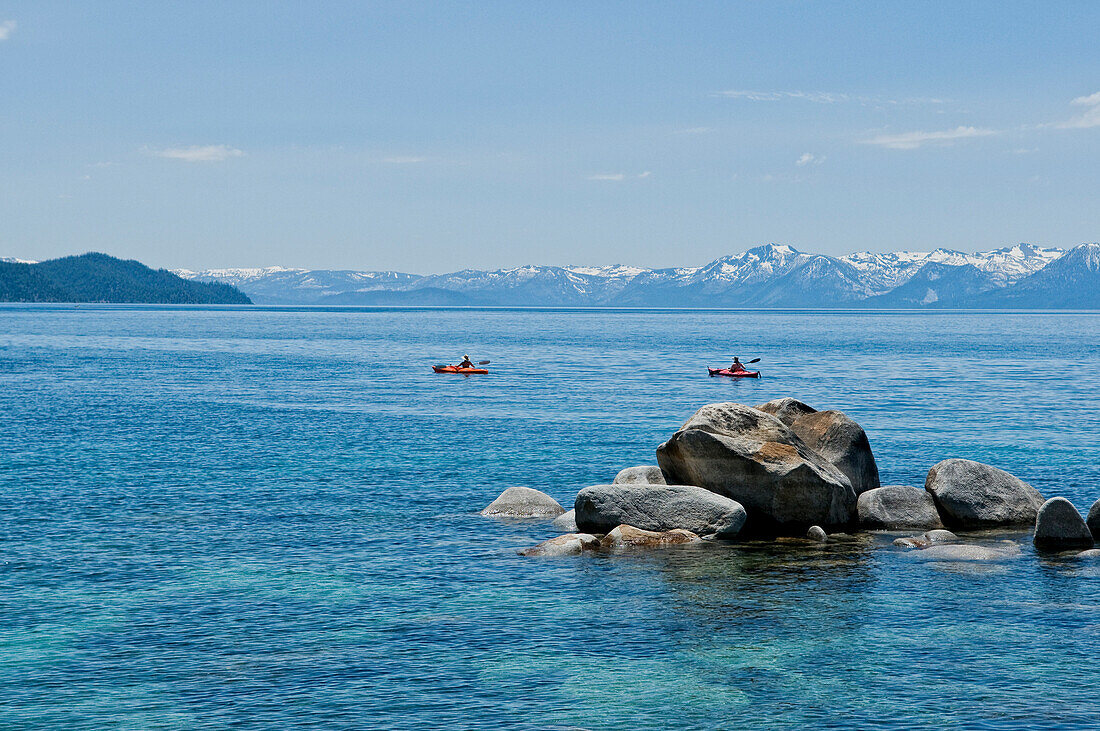 A pair of kayakers is out for a morning paddle along the shores of Lake Tahoe, Nevada Incline Village, Nevada, USA