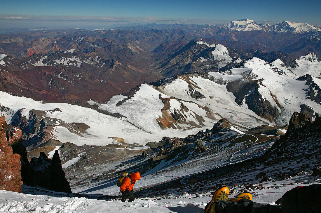 Mountaineer waiting for exhausted team member on summit day on Aconcagua, Mendoza, Andes Mountains, Argentina