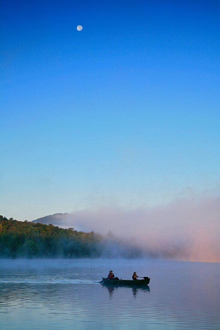 Canoeing in morning fog on Lake Eaton, Adirondack Park, USA, Long Lake village, NY, USA