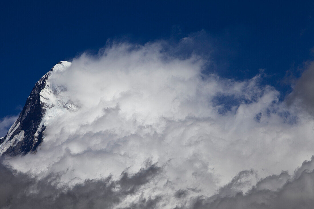 A cloud system builds from the south face of Annapurna South Annapurna Conservation Area, Nepal