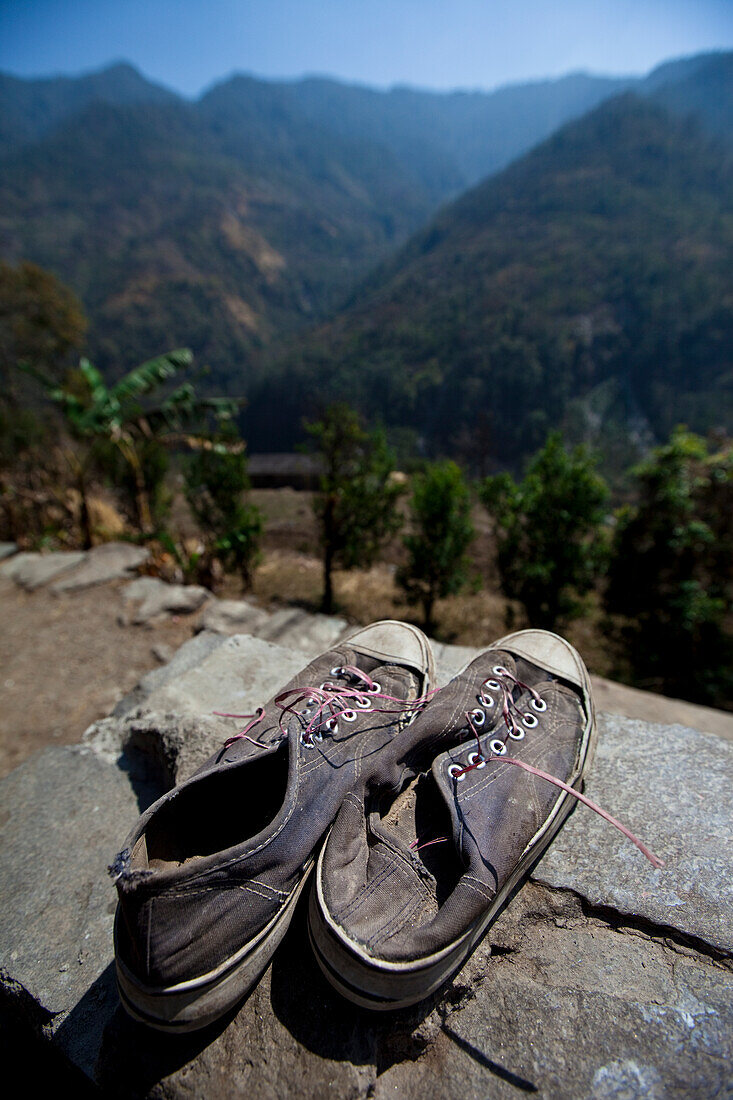 Old shoes point off towards the Himalayan foothills in Nepal Annapurna Conservation Area, Nepal