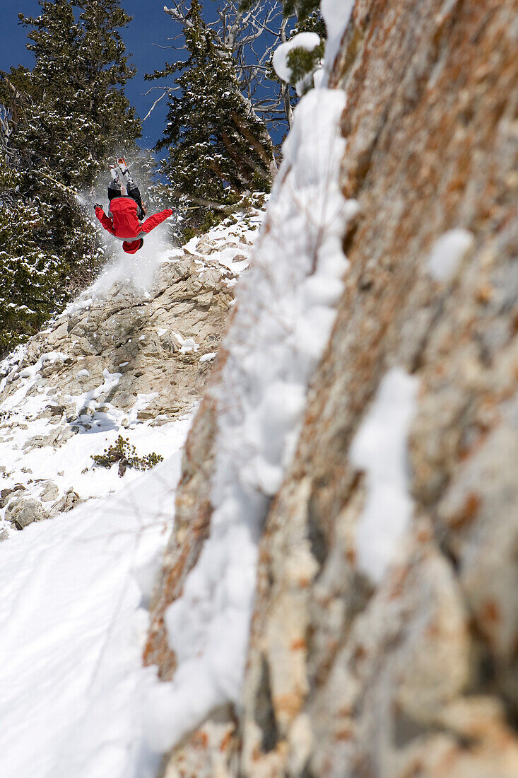 A man doing a front flip into some fresh snow at Snowbird, Utah, Utah, USA