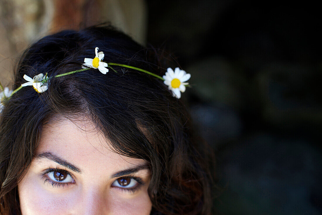 Flowers on female's dark hair San Diego, CA, USA