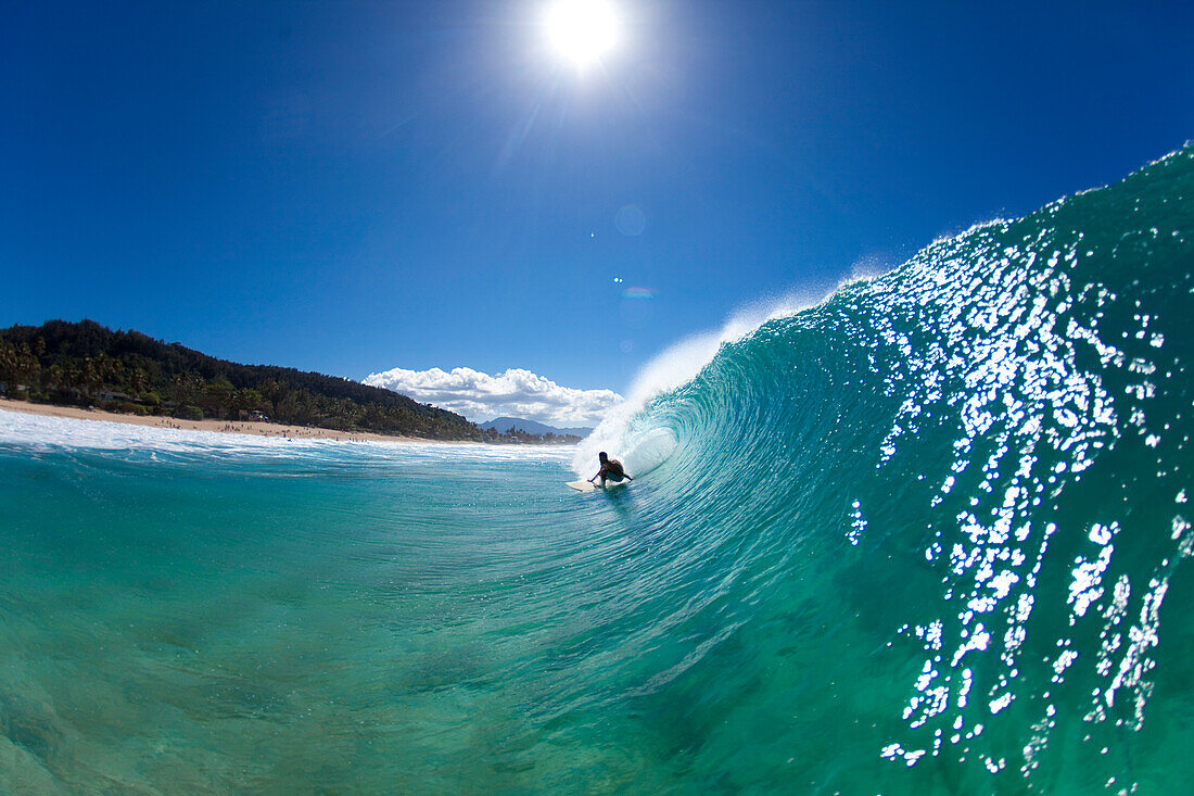 A water view of a surfer getting barreled at Pupukea Sandbar north shore of Oahu, Hawaii, USA