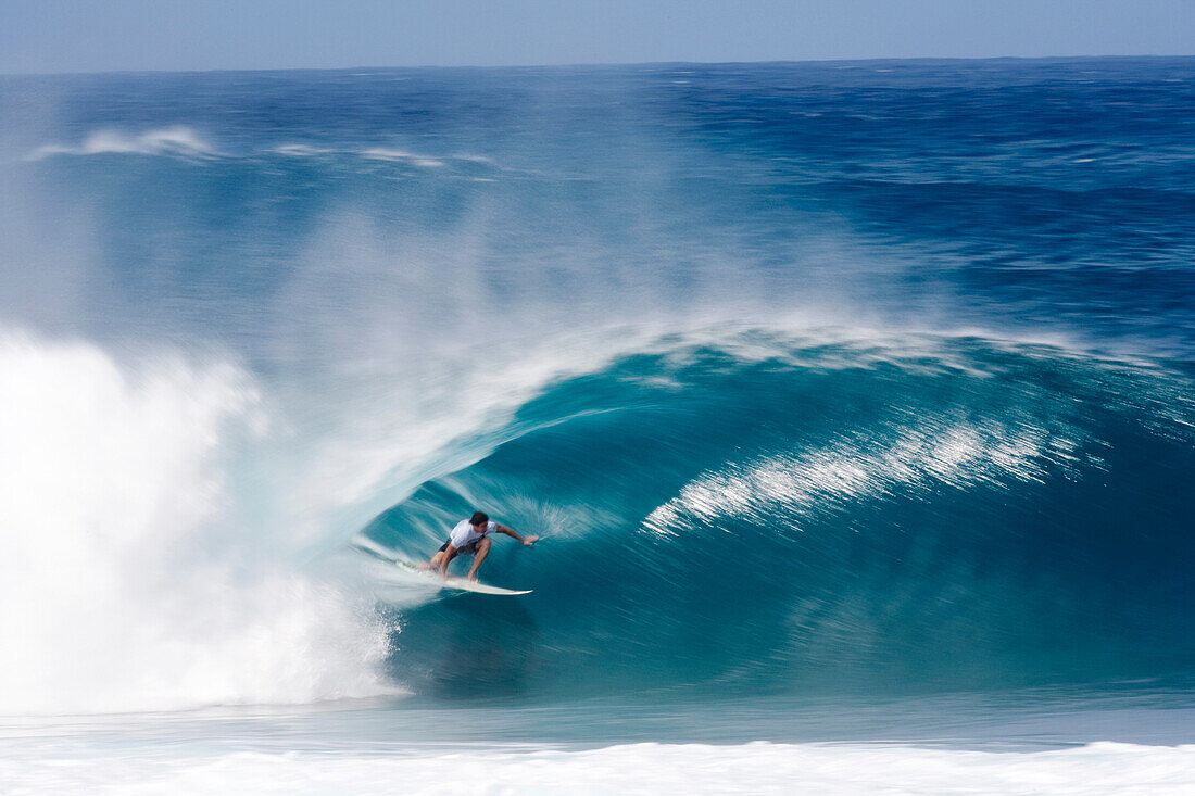 A surfer inside a perfectly tubing wav at Pipeline north shore of Oahu, Hawaii, USA