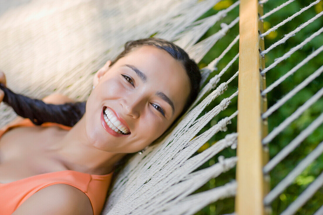 Hispanic woman laying in hammock, Seattle, WA