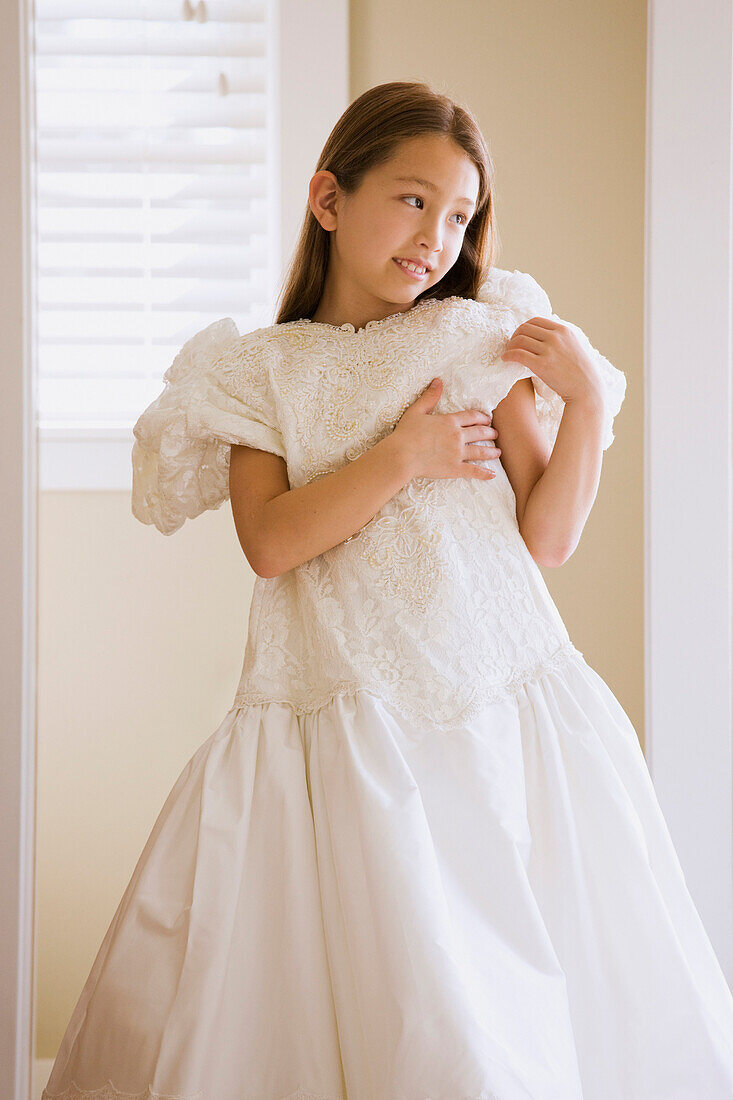 Asian girl trying on wedding dress, Seattle, WA