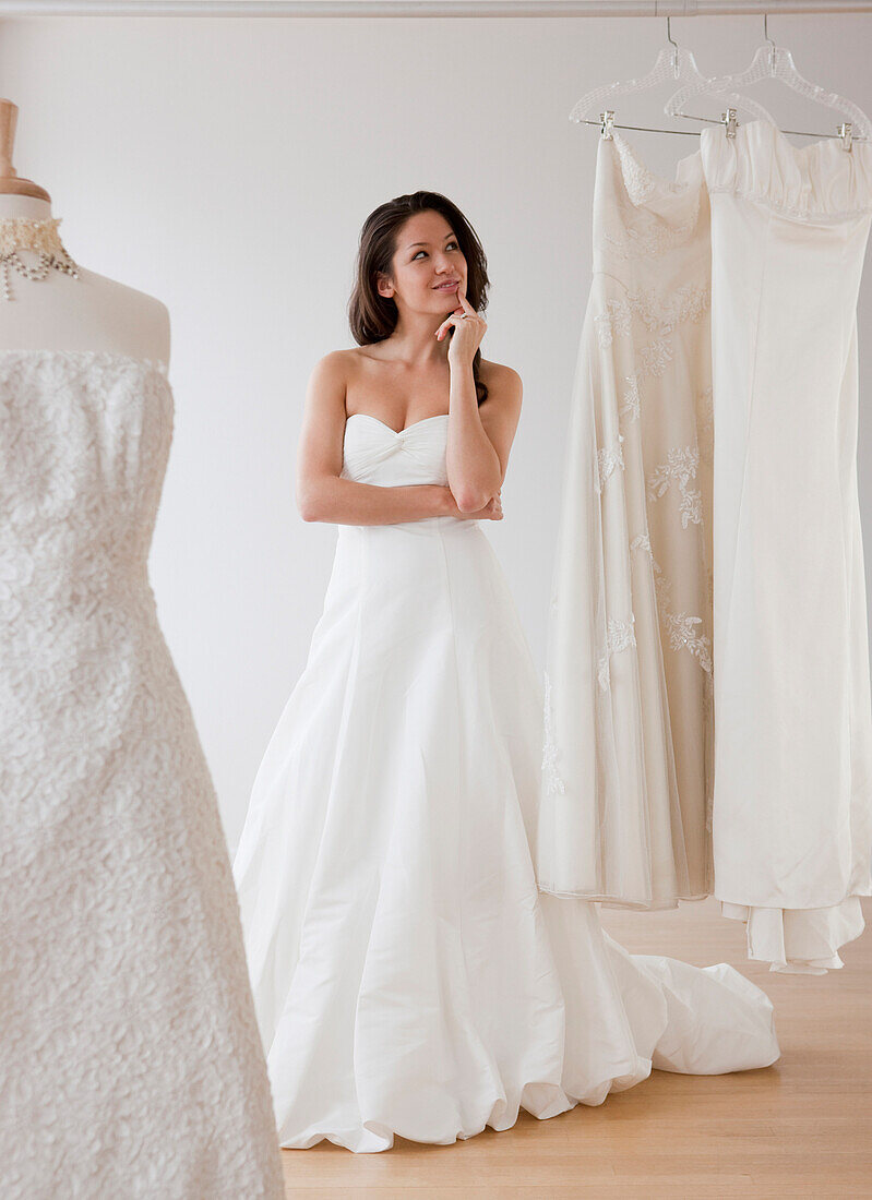 Mixed race woman trying on wedding dresses, Jersey City, NJ