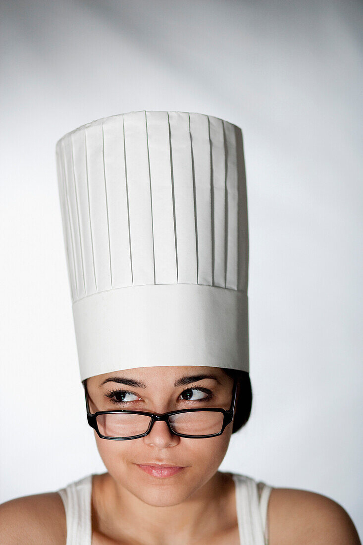 Hispanic woman in chef's hat and eyeglasses, New York, NY