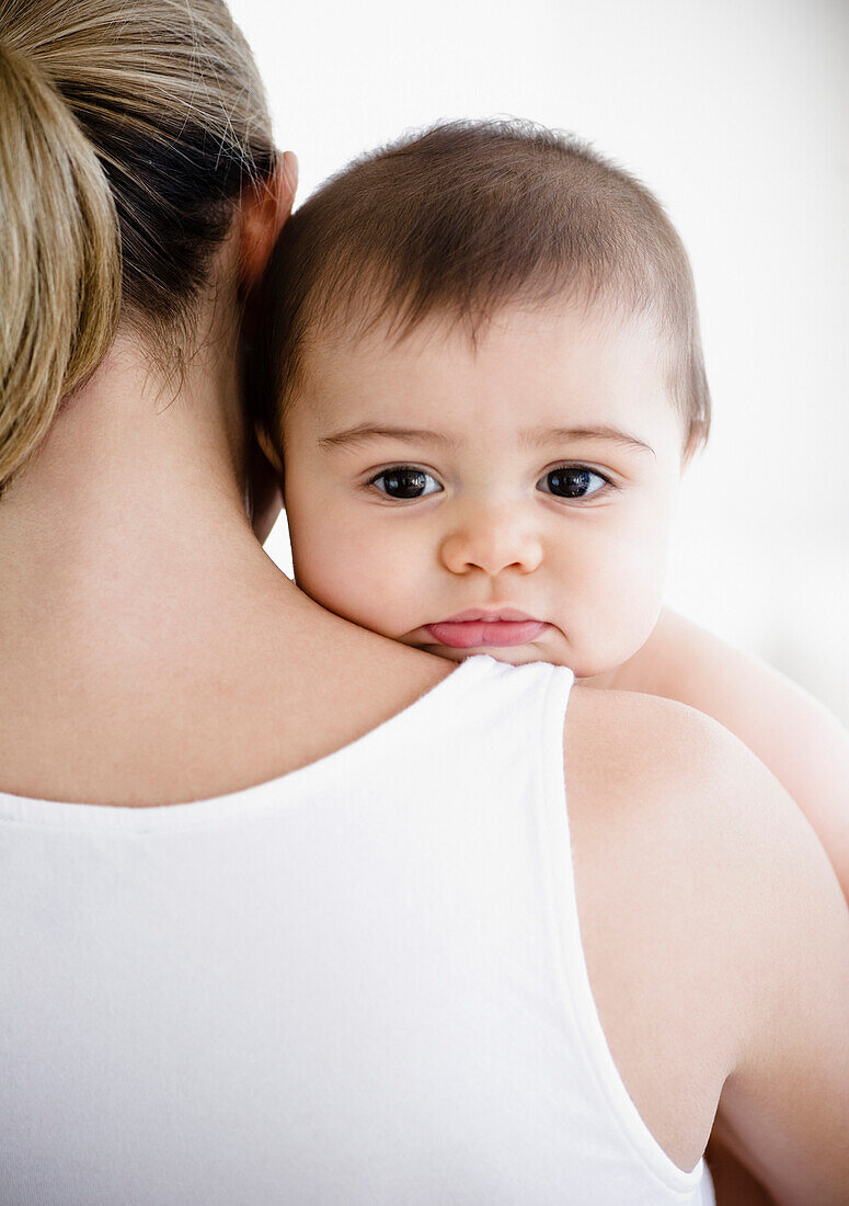 Mother holding mixed race baby boy, Jersey City, New Jersey, United States