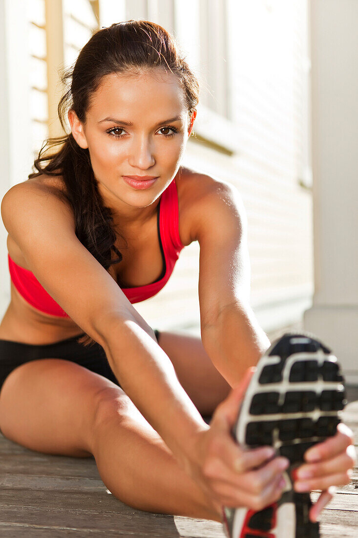 Mixed race woman warming up before exercise, Seattle, WA, USA