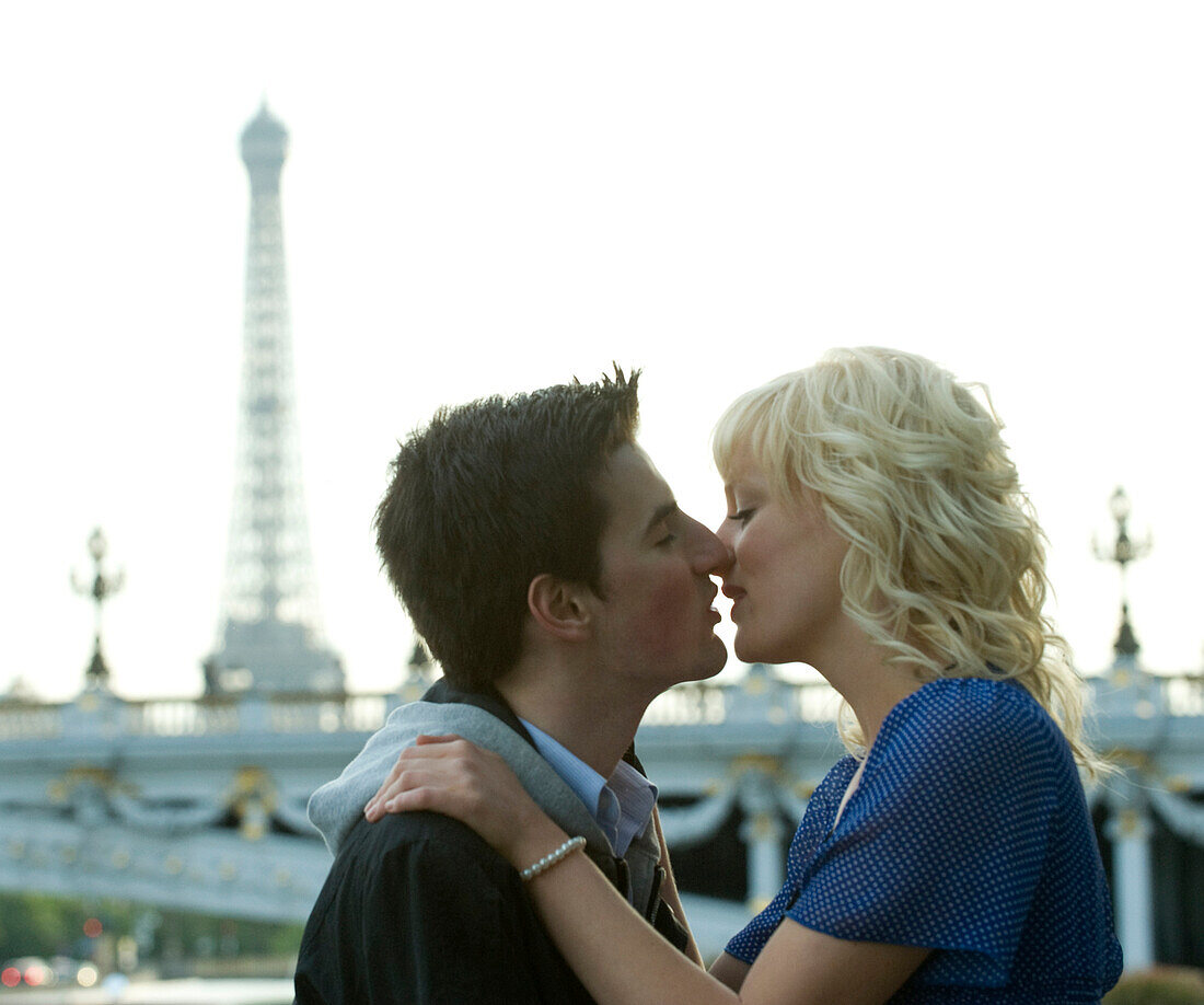 Caucasian man kissing girlfriend near Eiffel Tower, Paris, Paris, France