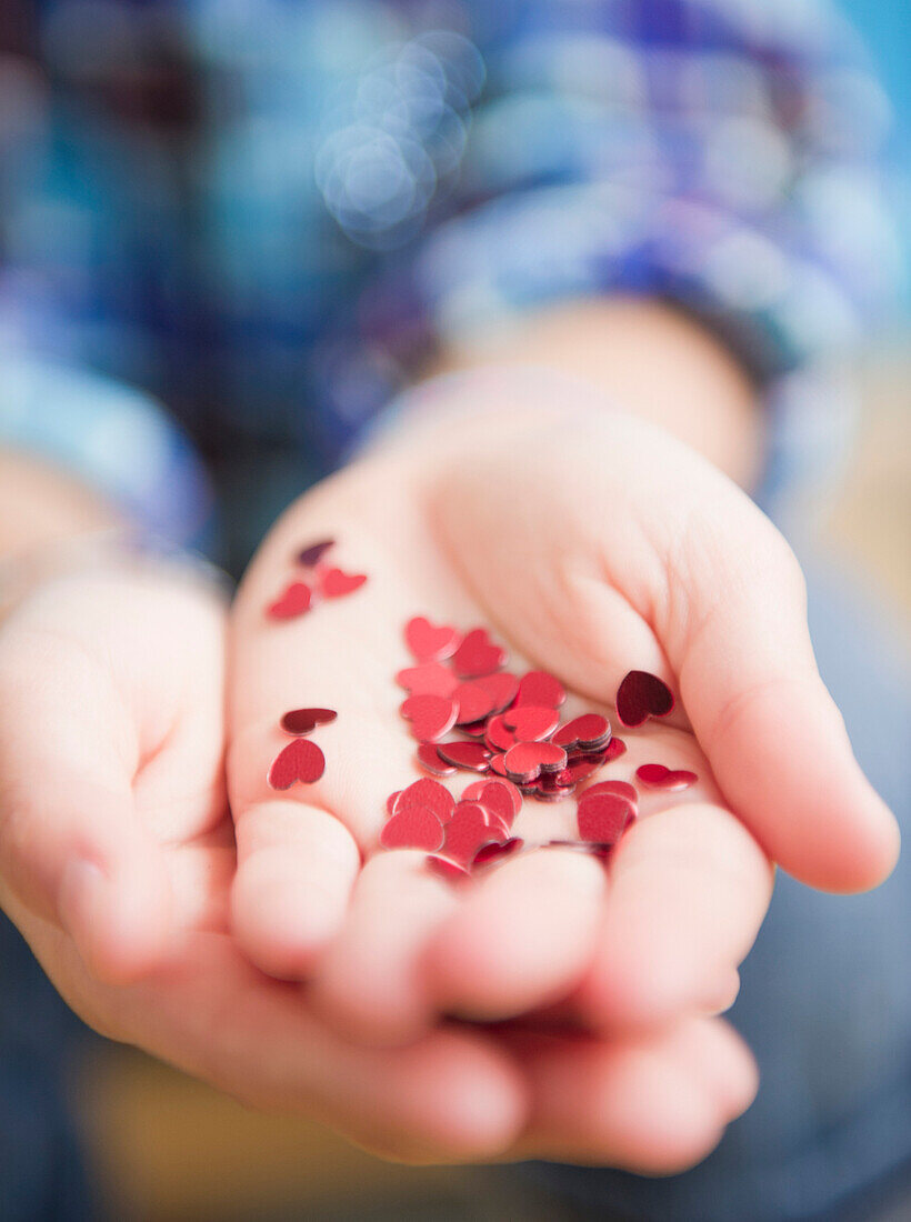 African American girl holding handful of hearts, Jersey City, New Jersey, USA