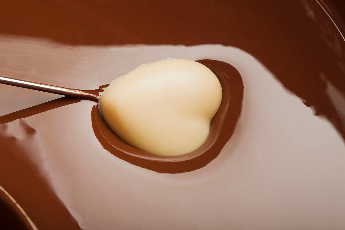 Heart-shaped candy being dipped in chocolate, Caracas, Caracas, Venezuela