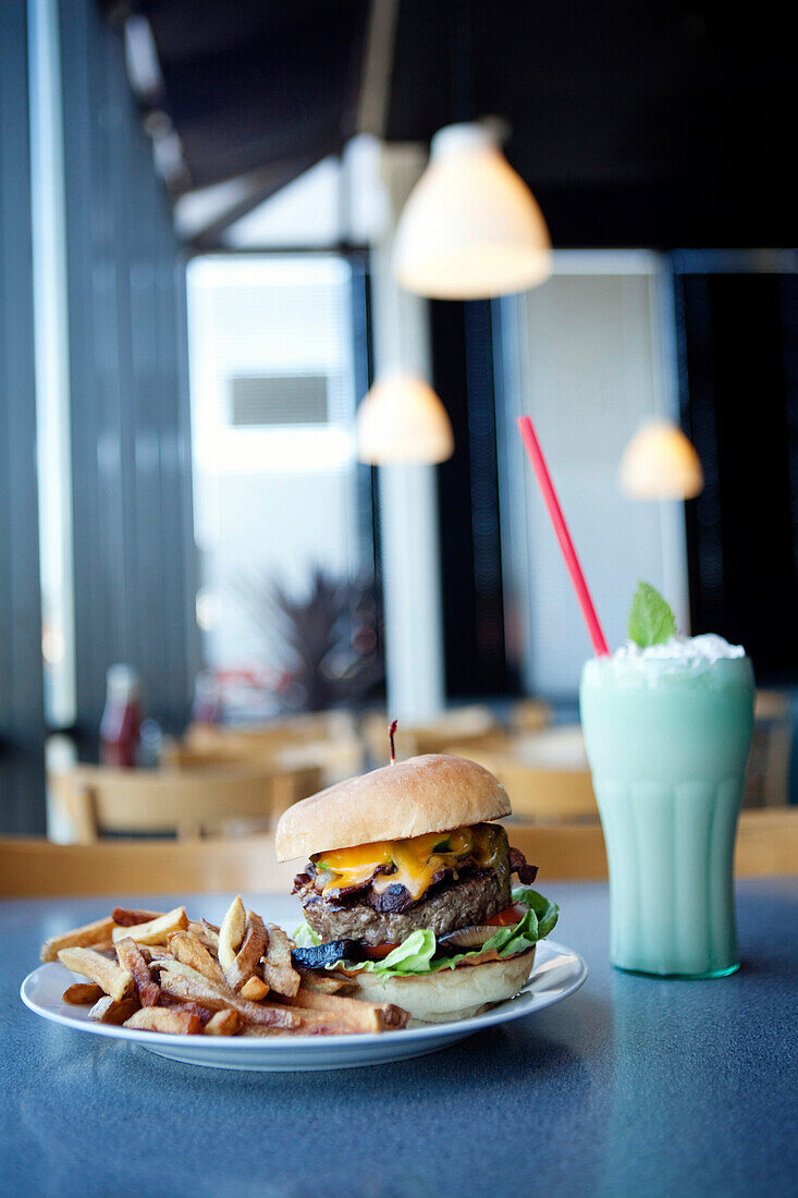 Cheeseburger, french fries and milkshake in diner, Sacramento, California, United States