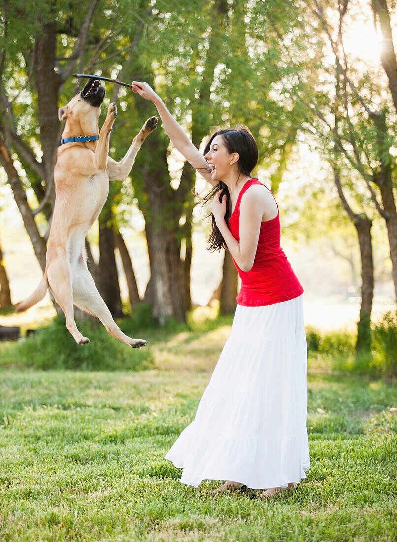 Caucasian woman playing with dog, Lehi, Utah, United States