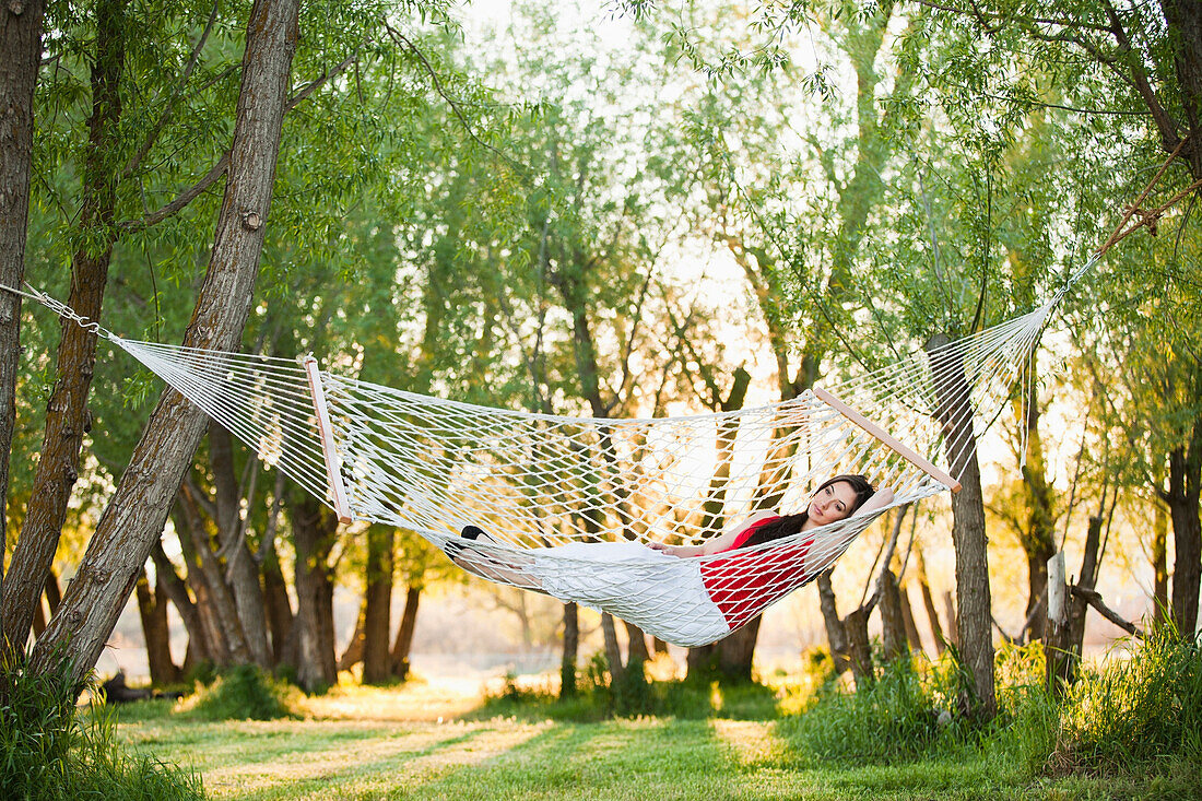 Caucasian woman laying in hammock, Lehi, Utah, United States