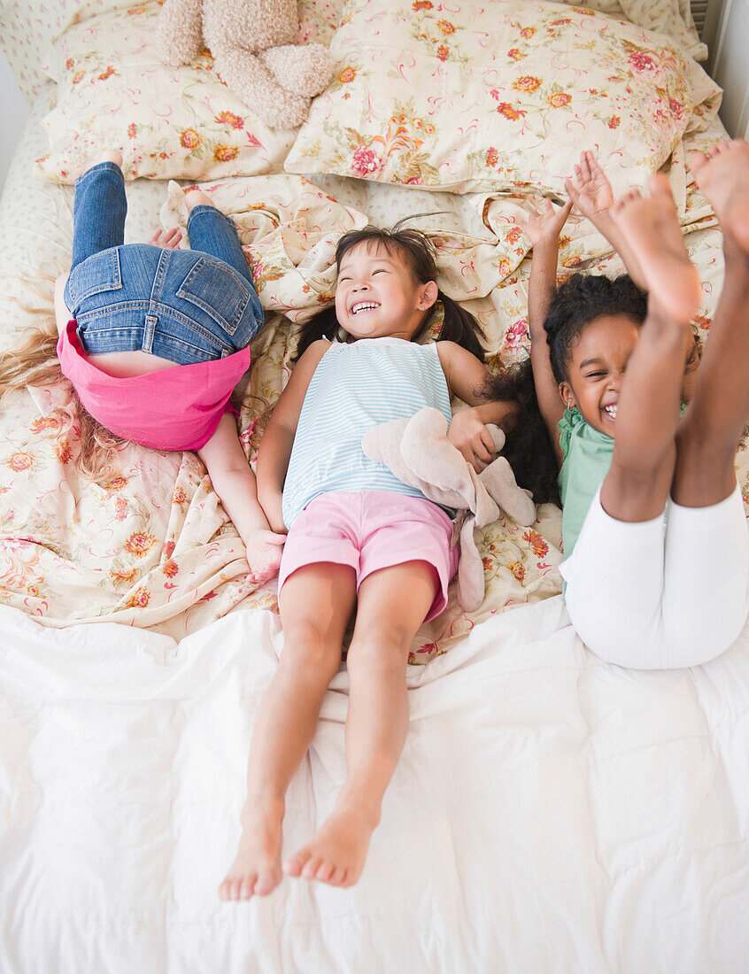Girls playing on bed together, Jersey City, New Jersey, USA