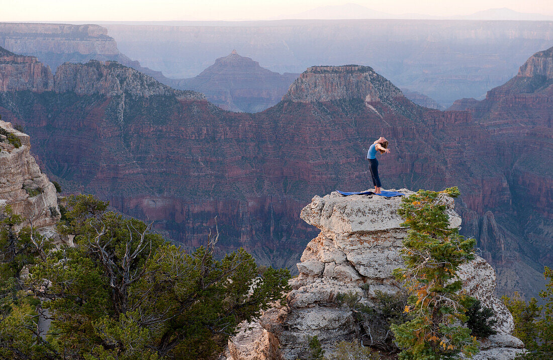 Caucasian woman practicing yoga on top of rock formation, Grand Canyon, Arizona, United States