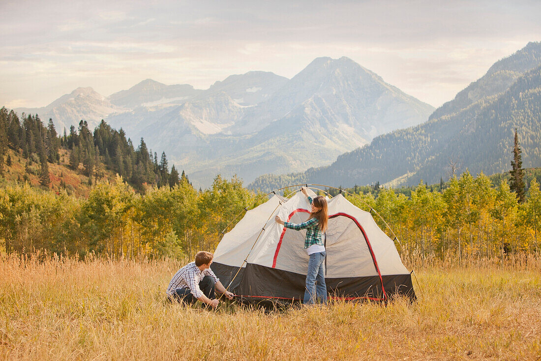 Caucasian couple setting up tent, Park City, Utah, USA