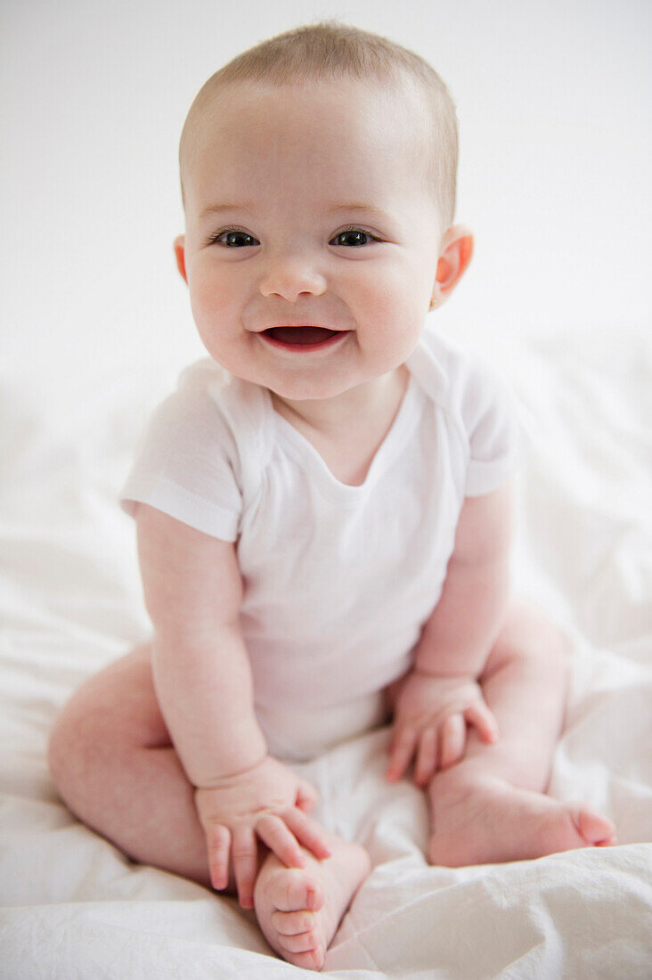 Caucasian baby girl sitting on floor, Jersey City, New Jersey, USA