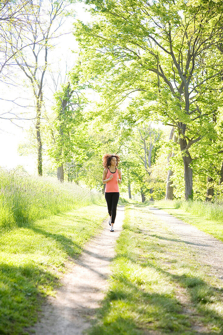 Hispanic woman running in park, Hingham, Massachusetts, United States