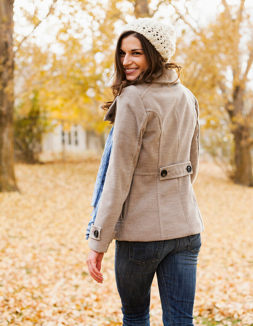 Caucasian woman walking in autumn leaves, Alpine, Utah, USA