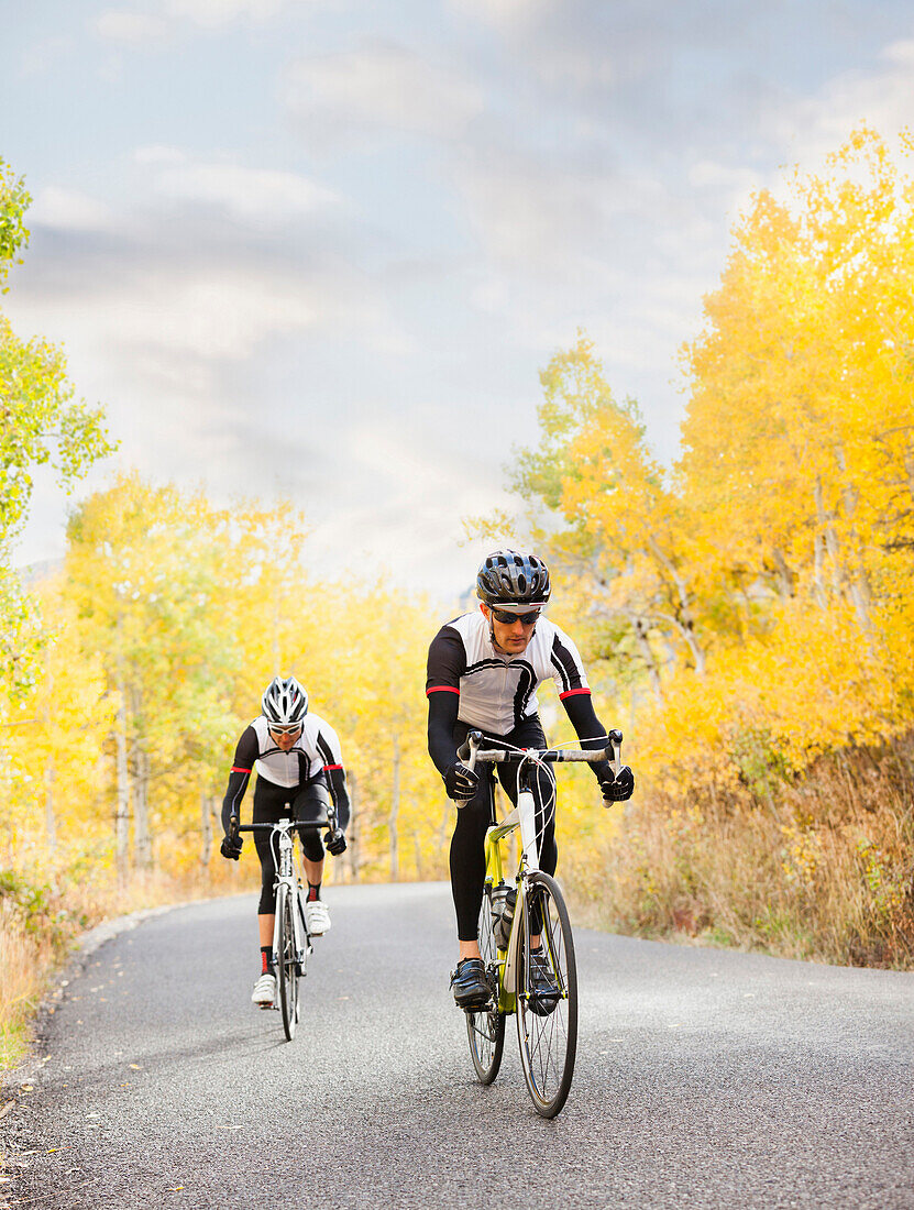 Caucasian cyclists on rural road, Lehi, Utah, USA
