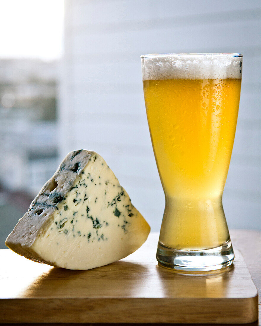Glass of beer with wedge of cheese, SAN FRANCISCO, California, USA