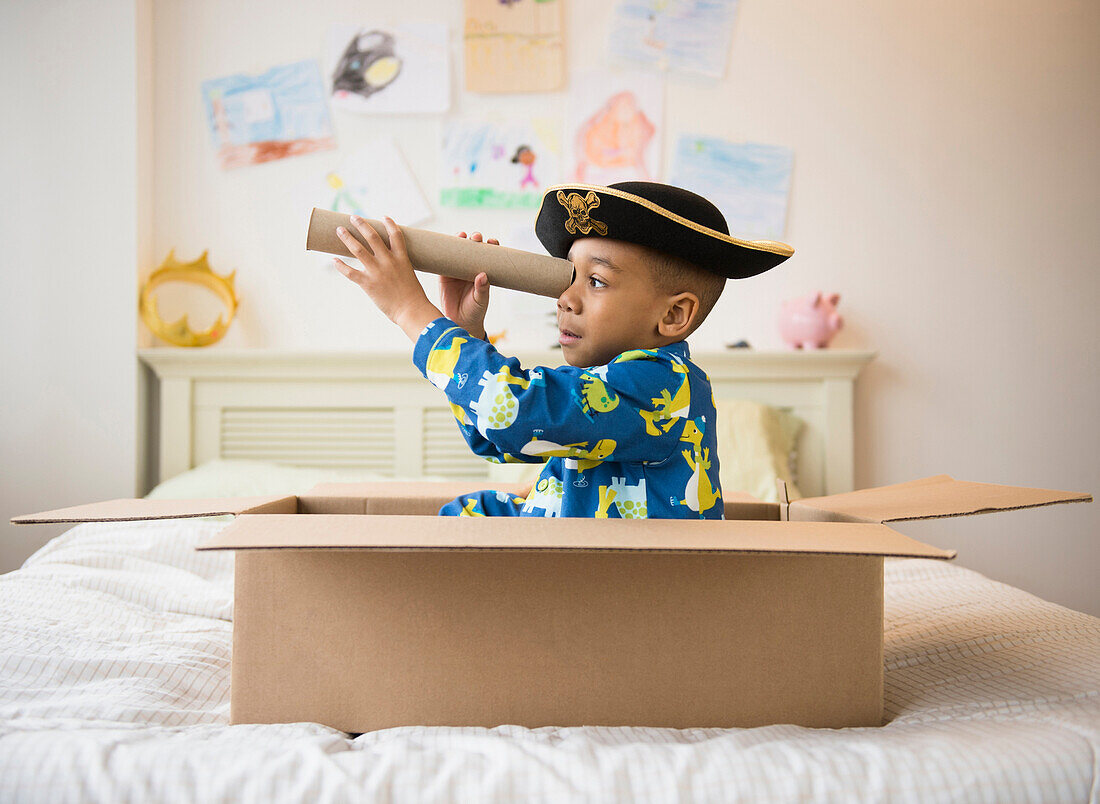 African American boy playing in cardboard box, Jersey City, New Jersey, USA