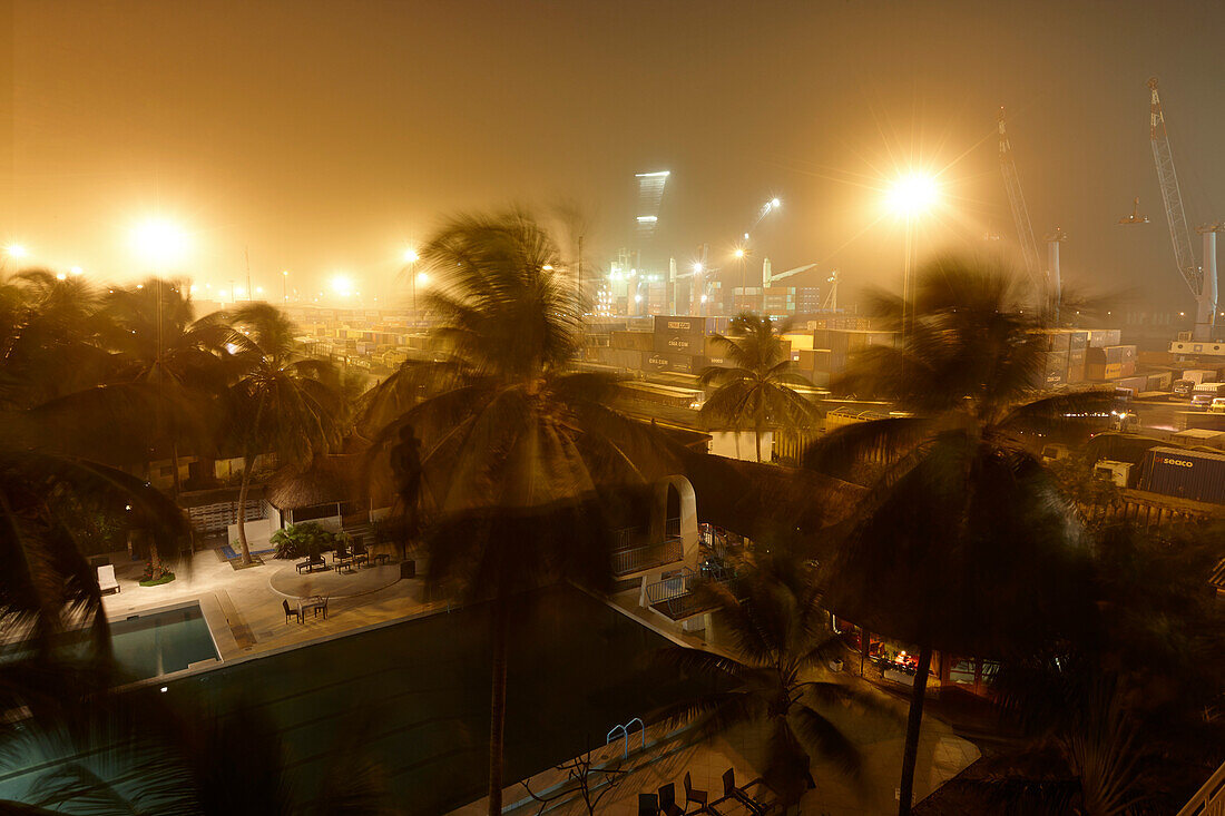 Swimming pool of a hotel, port of departure in background, Cotonou, Benin