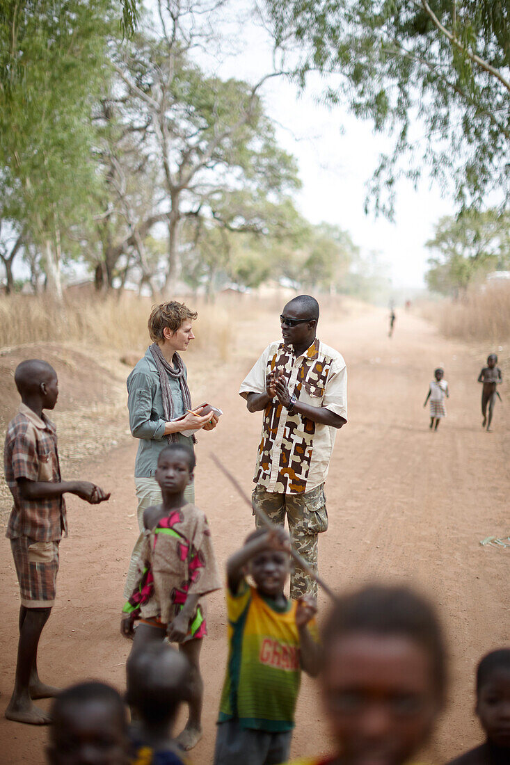 Journalist and guide visiting Tian Sa Wassaga village, out of Penjari National Park, Benin