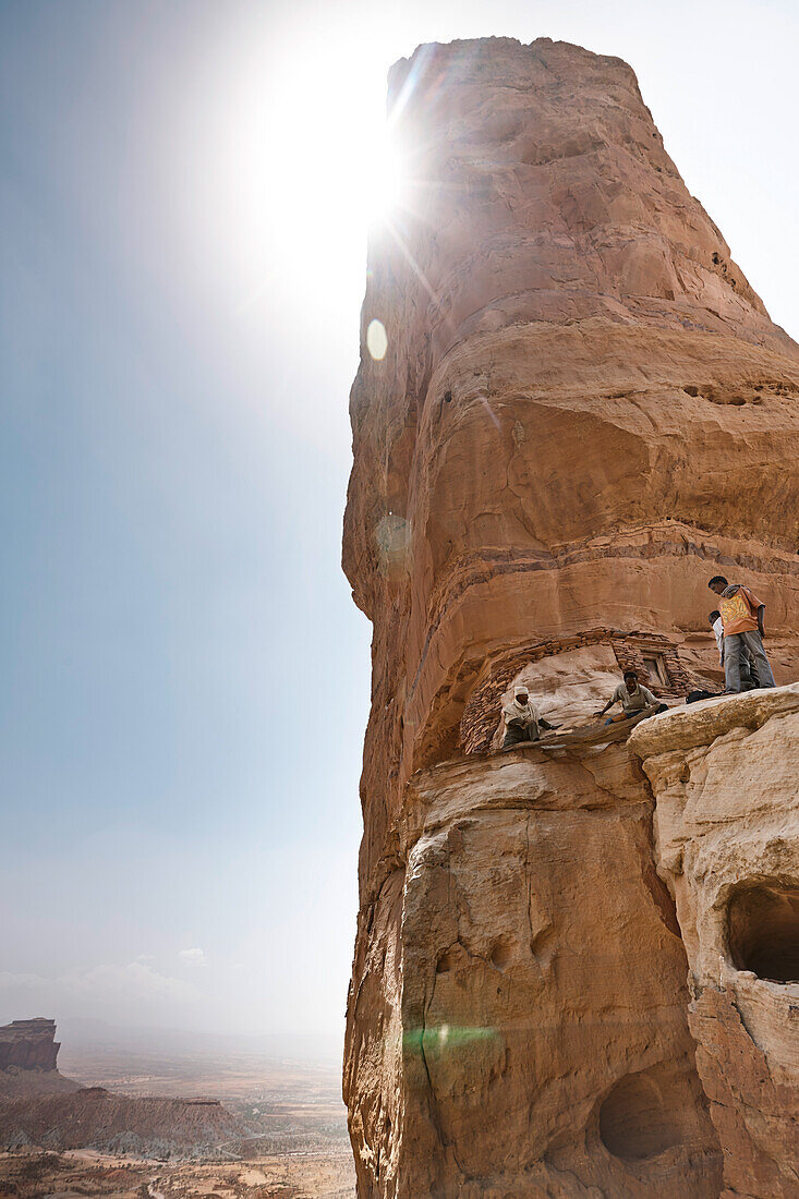 Men near entrance to monolithic church Abuna Yemata Guh, Hawzien, Tigray Region, Ethiopia