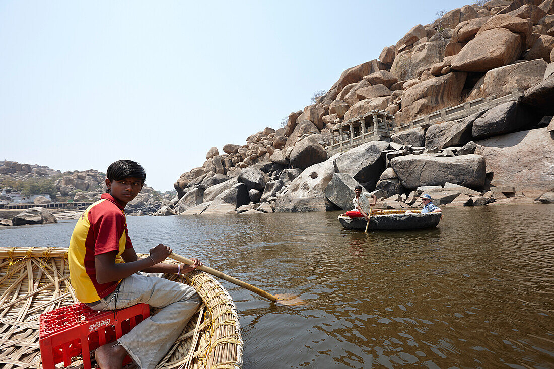 Boattrip in traditional round Coracle rowing boats, Tungabhadra River, Hampi, Karnataka, India