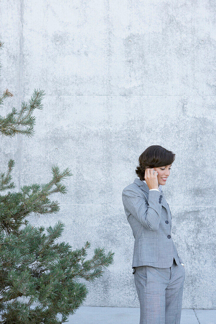 Hispanic businesswoman talking on cell phone, Vancouver, Canada