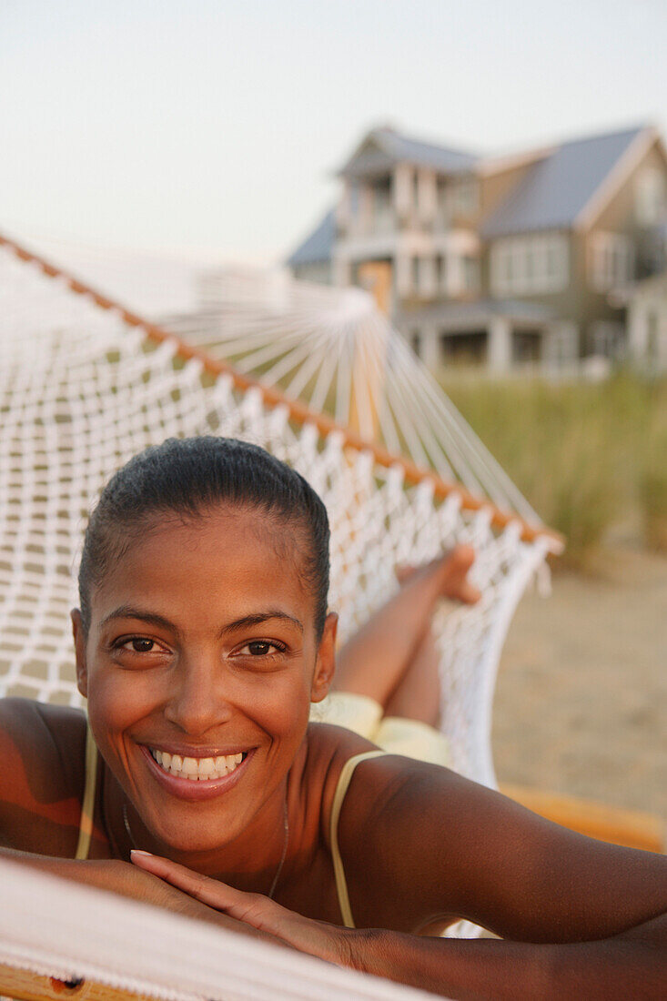 African woman laying in hammock at beach, Norfolk, VA